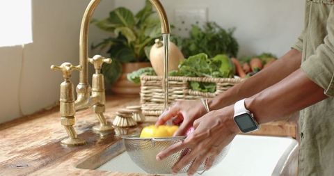 Washing Fresh Vegetables in Farmhouse Kitchen