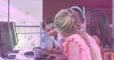 Elementary Girls Coding Together on Classroom Computers, Learning STEM and Teamwork