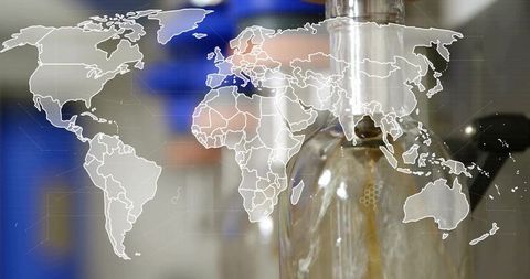 Beverage bottling machinery with world map overlay