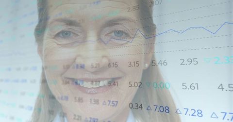 Senior female executive smiling with translucent market data overlay, finance leadership