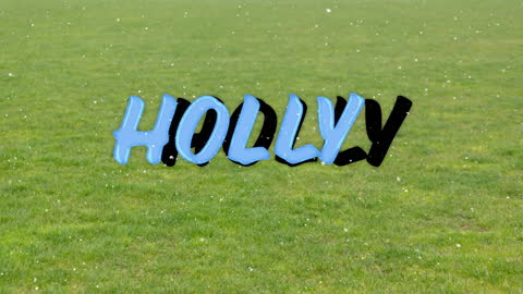 Festive Snow Animation Over Holly Text on Green Grass