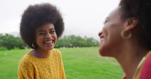 Joyful Twins Enjoying Day Outdoors in Park Setting
