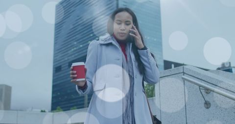 Woman Commuting to Work Holding Coffee and Talking on Smartphone