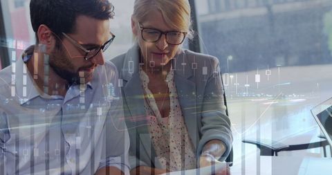 Financial experts analyzing data with technology interface