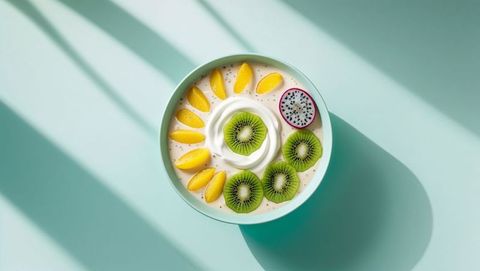Colorful smoothie bowl with fresh fruits on pastel background