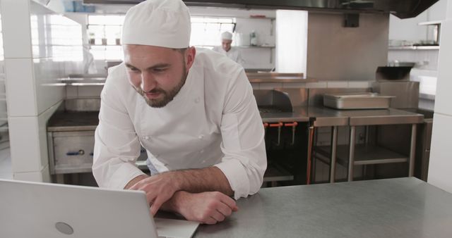 Chef in Professional Kitchen Using Laptop for Culinary Planning - Download Free Stock Images Pikwizard.com