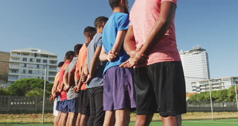 Soccer Players Lining Up on Sunny Field