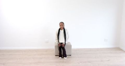 young girl in thoughtful contemplation in minimalist room - Download Free Stock Images Pikwizard.com