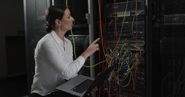 Female IT Professional Working on Server Room Wiring with Laptop - Download Free Stock Images Pikwizard.com
