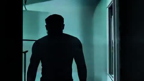 Silhouette of Mysterious Man Emerging in Urban Corridor