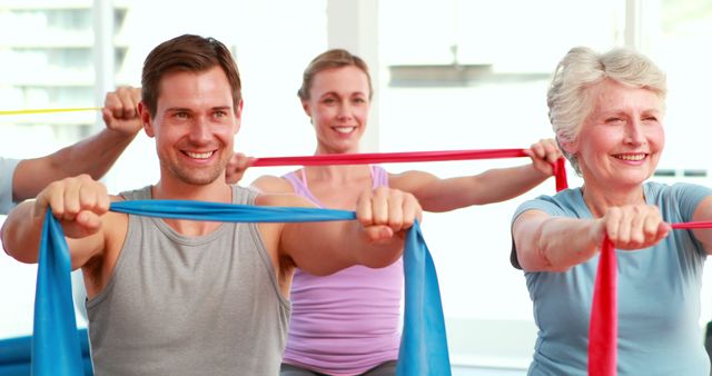 Mixed Age Group Exercising with Resistance Bands in Fitness Class - Download Free Stock Images Pikwizard.com