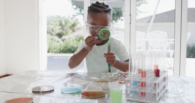 African american boy sitting at table doing chemistry experiments at home - Download Free Stock Photos Pikwizard.com