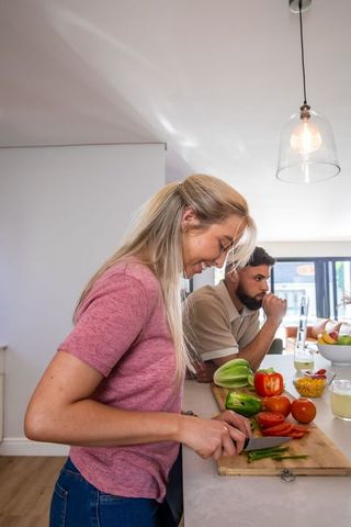 Couple preparing healthy meal together at kitchen counter
