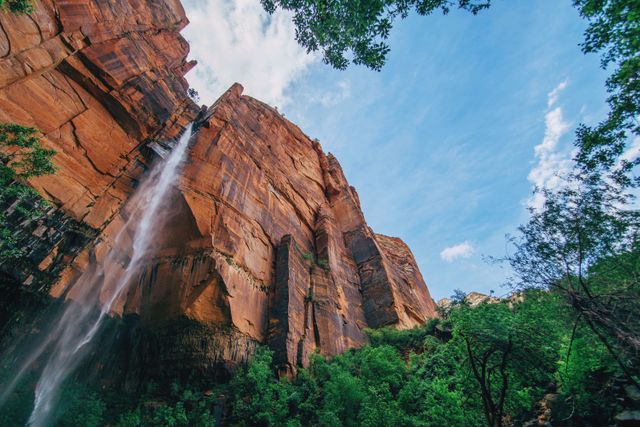 Majestic Waterfall Cascades Over Red Rock Cliffs in Desert Canyon - Download Free Stock Photos Pikwizard.com