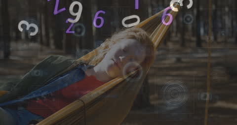 Digital Data Animation Around Relaxing Woman in Hammock