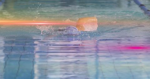 Female swimmer performing front crawl in lap pool