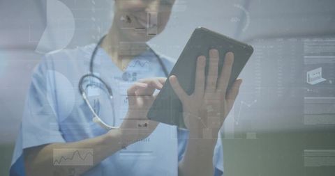 Female clinician holding tablet analyzing clinical data on digital healthcare dashboard