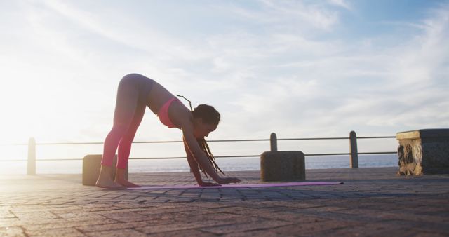 Woman Practicing Yoga at Sunrise on Seaside Promenade - Download Free Stock Images Pikwizard.com