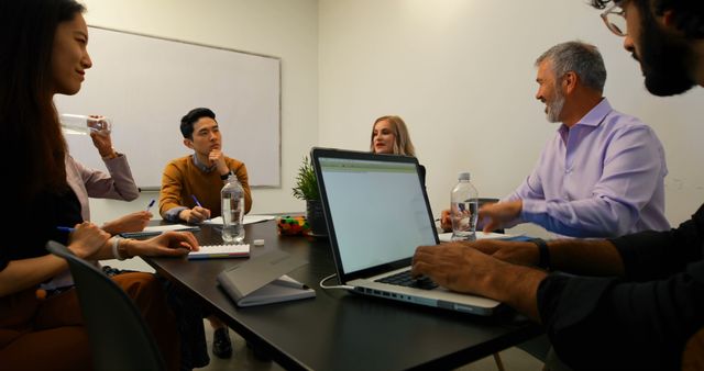 Diverse Team in Office Meeting Collaborating Around Conference Table - Download Free Stock Images Pikwizard.com