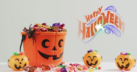 Halloween Pumpkin Bucket Filled with Assorted Candy and Decorations - Download Free Stock Images Pikwizard.com