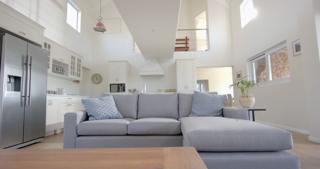 Gray sofa, fridge, furnitures and windows in sunny home - Download Free Stock Photos Pikwizard.com
