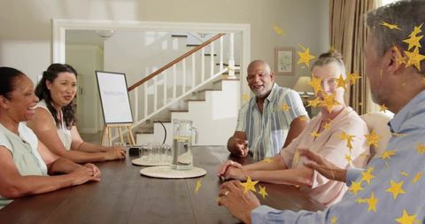Welcoming gathering sharing conversation around dining table with pitcher and welcome sign