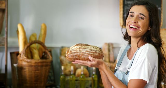 Smiling Baker Holding Freshly Baked Bread in Shop - Download Free Stock Images Pikwizard.com