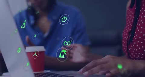 Eco-Friendly Metrics Floating Around Laptop in Collaborative Workspace