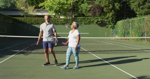 Senior Couple Enjoying Friendly Tennis Match Outdoors - Download Free Stock Images Pikwizard.com