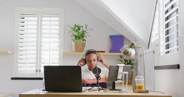 Focused Young Man Wearing Headphones Hosting Podcast from Home Studio - Download Free Stock Images Pikwizard.com