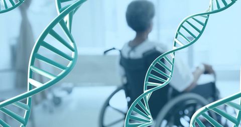 Dna strands overlaying disabled person in wheelchair