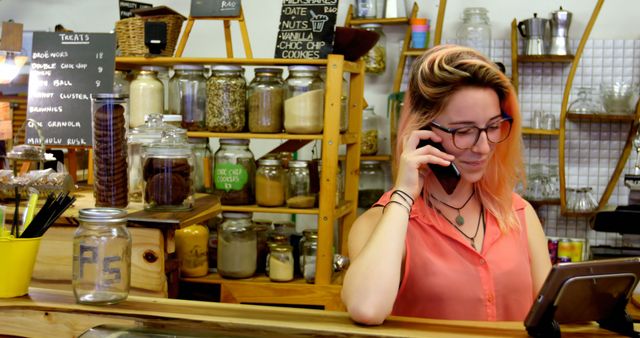 Young Woman Managing Cafe with Phone and Digital Tablet - Download Free Stock Images Pikwizard.com