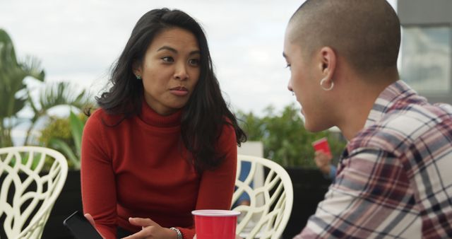 Diverse Friends Having Serious Conversation Outdoors with Red Cups - Download Free Stock Images Pikwizard.com