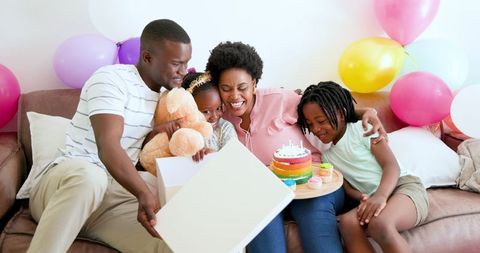 Joyful Family Birthday Celebration with Teddy Bear and Cake