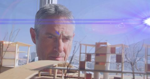 Architect Analyzing Architectural Model with Lens Flare Effect - Download Free Stock Images Pikwizard.com