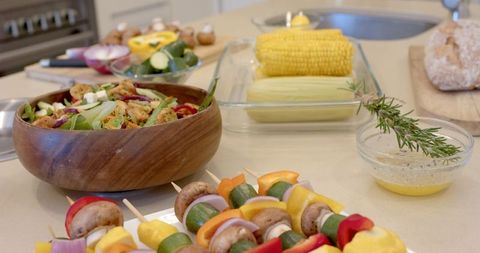 Rustic Vegetarian Feast with Sizzling Skewers and Fresh Produce