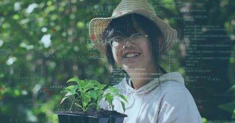 Smiling child holding seed tray in garden with code overlay blending nature and technology
