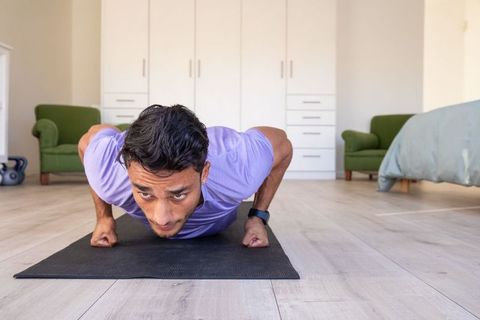 Focused Athlete Doing Push-Ups on Mat in Home Workout Session