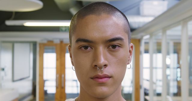 Close-up of Confident Young Man with Piercings Indoors - Download Free Stock Images Pikwizard.com