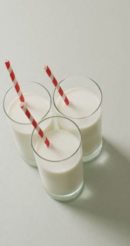 Three Glasses of Milk with Red and White Straws on Gray Background - Download Free Stock Images Pikwizard.com