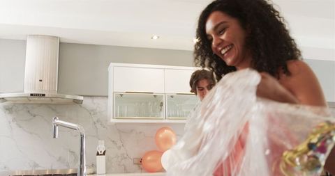 Couple Post-Party Cleanup in Modern Kitchen Setting