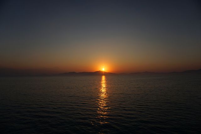 Serene Sunset Over Tranquil Ocean Waters Reflecting Golden Light - Download Free Stock Photos Pikwizard.com