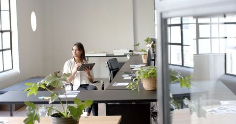 Professional Woman Using Digital Tablet in Contemporary Office