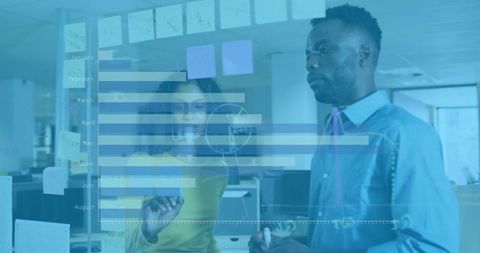 Diverse team analyzing graph in modern office