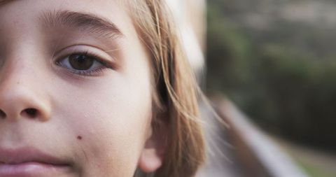 Close-Up of Smiling Child Outdoors in Natural Light