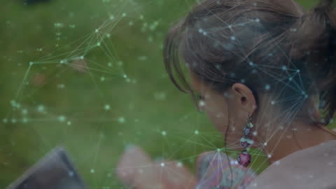 Woman Using Laptop in Park with Digital Connections Overlay