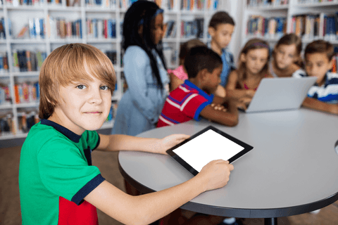 Boy engaged with digital tablet in transparent learning environment
