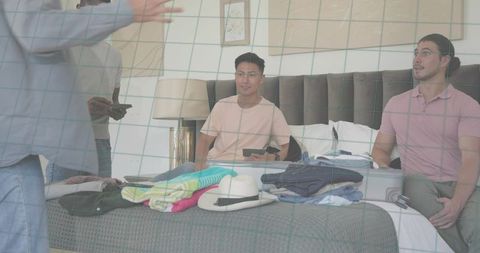 Friends Unpacking Luggage on Hotel Bed Planning Group Trip and Organizing Clothes