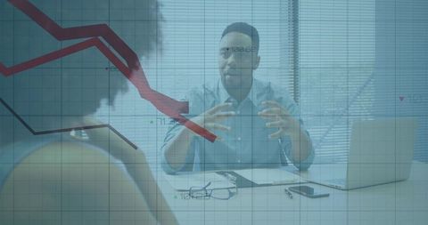Business leader explaining strategy during meeting with downward financial chart overlay
