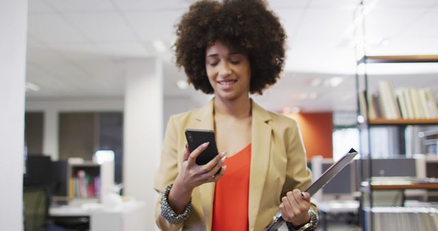 Confident Businesswoman Checking Smartphone in Modern Office - Download Free Stock Images Pikwizard.com